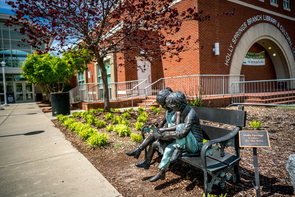 sculpture in front of holly springs nc library