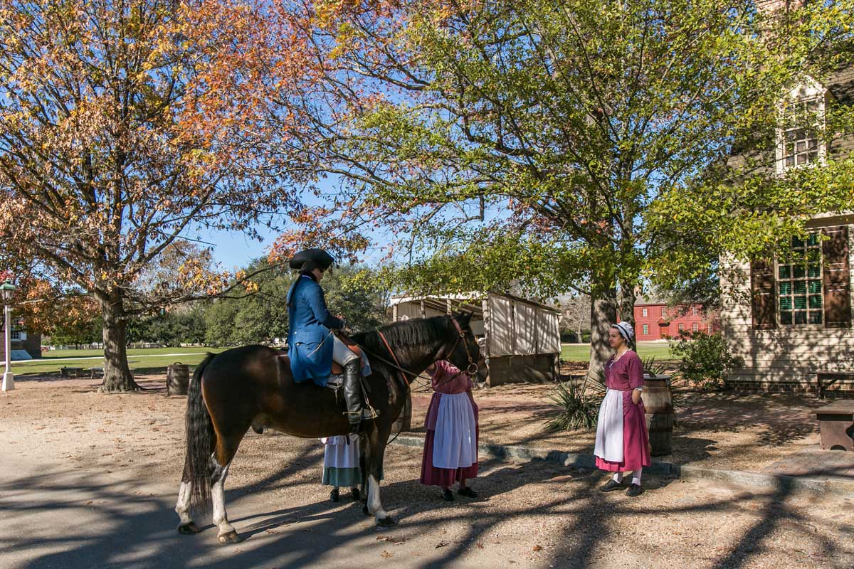 People in colonial costumes on a horse in Williamsburg, VA