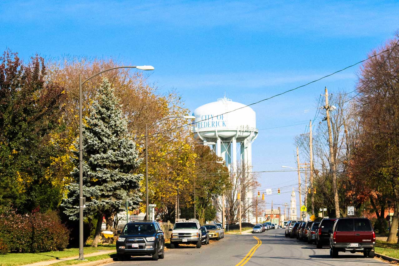 Street with city of Frederick water tower in Frederick, MD