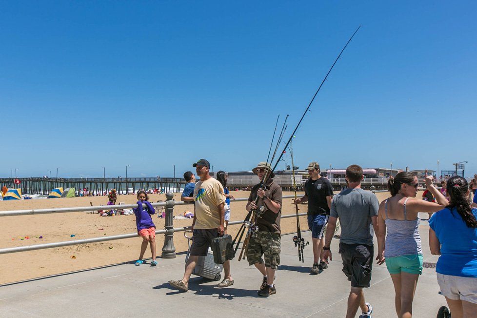 people walking on boardwalk with fishing poles virginia beach va